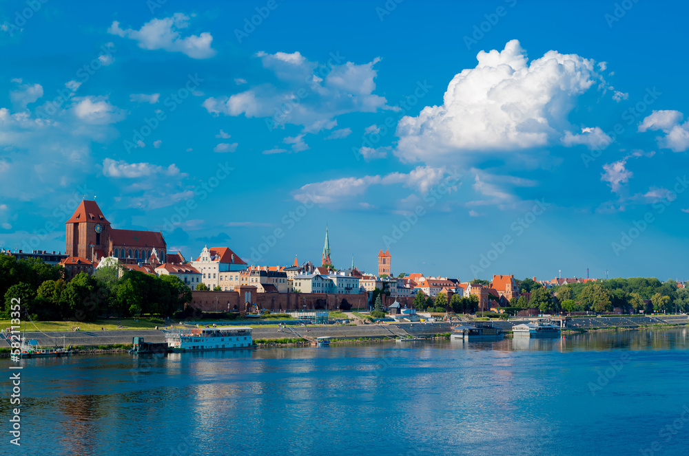 View of Old City of Torun. Vistula (Wisla) river against the backdrop of the historical buildings of the medieval city of Torun. Poland. Europe