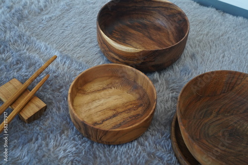 Fototapeta Naklejka Na Ścianę i Meble -  Asian wooden bowl, wooden plate, with chopsticks set of wooden tableware.