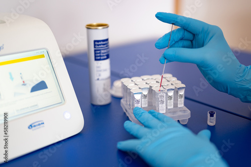 Rapid COVID-19 test for detection of specific antibodies IgM and IgG to novel corona virus SARS-CoV-2 causing Covid-19 illness. Medic or doctor in protective gloves collects blood from patient finger
