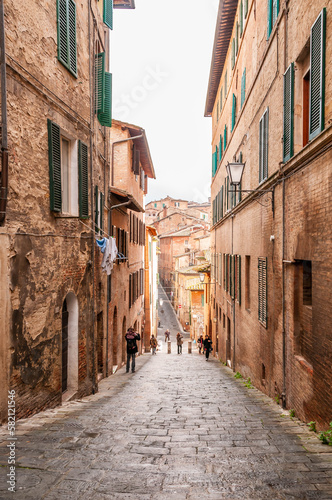 Old narrow street in the city of Siena  Tuscany  Italy