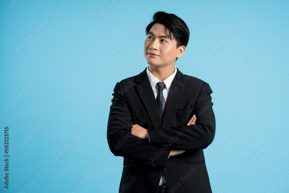 Portrait of young businessman posing on blue background Portrait of young businessman posing on blue background
