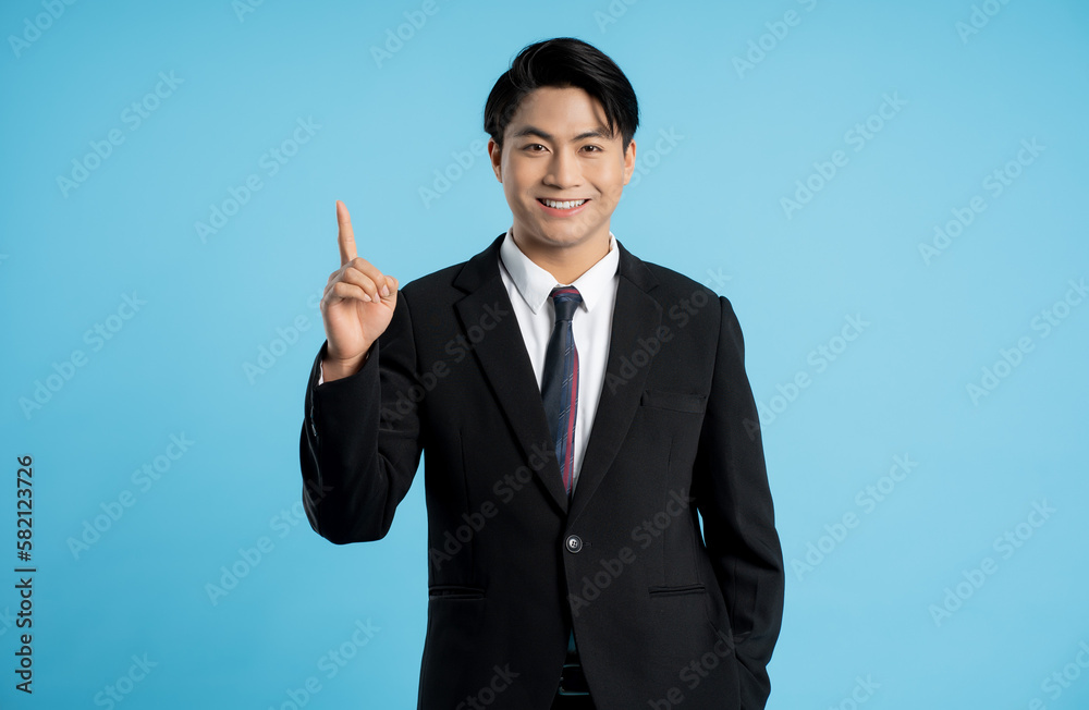 Portrait of young businessman posing on blue background Portrait of young businessman posing on blue background