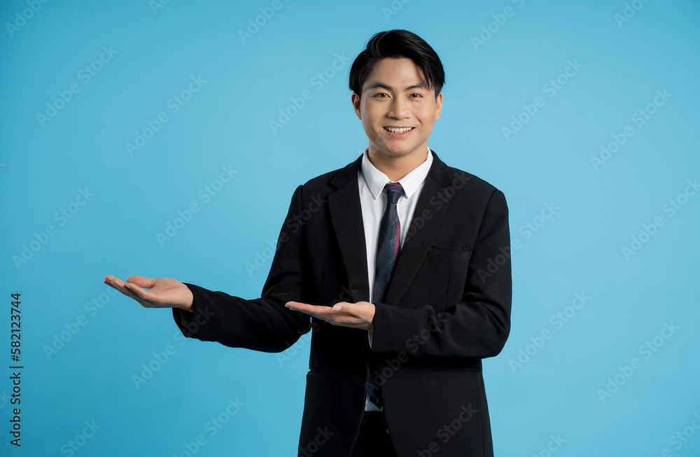 Portrait of young businessman posing on blue background Portrait of young businessman posing on blue background