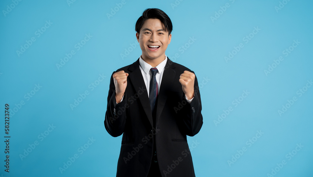 Portrait of young businessman posing on blue background Portrait of young businessman posing on blue background