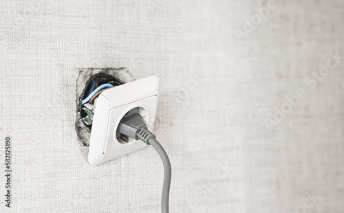 Dangerous bad,broken socket,plug in bathroom,falling out of wall. Outlet installation in old apartment. Poor electrical wire,repair.Terrible do-it-yourself repairmen.Short circuit risk,electric shock