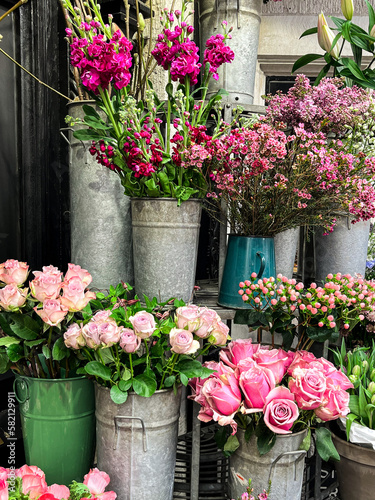 Bright flower stalls somewhere in London. Roses  tulips  and all other vibrant flowers placed in buckets and bouquets. These are the beauty for the eye.