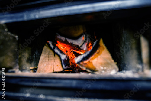 A close-up of a wood burning Kachelofen oven in Alsace, France. Heat and CO2 emissions from the hot surface provide warmth for the home.
