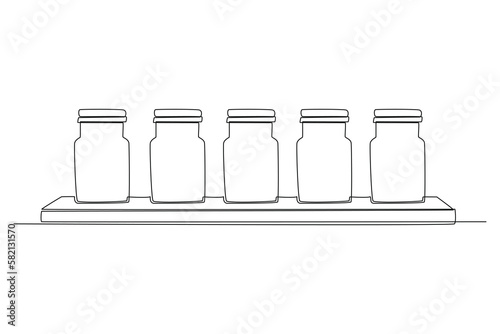 Single one-line drawing of a set of spice jars in the kitchen. Kitchen room concept continuous line draw design graphic vector illustration