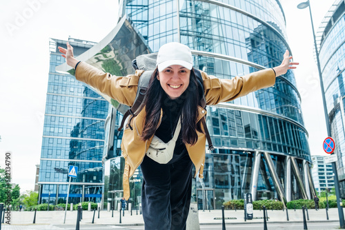 Obraz na płótnie Smiling tourist woman in Warsaw's modern center with skyscrapers w salonie