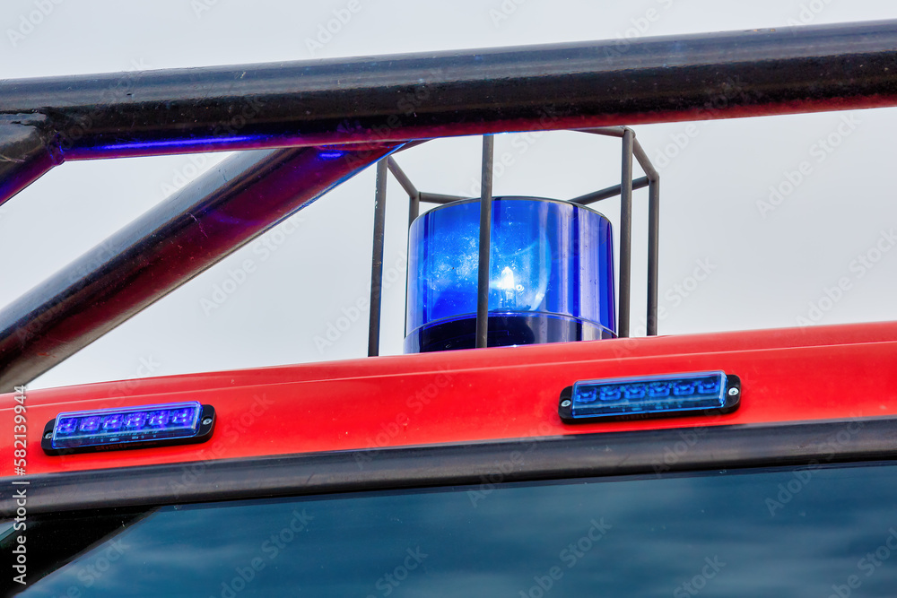 Fototapeta premium Blue Blinking Light on Top of Fire Truck - Emergency Services Concept