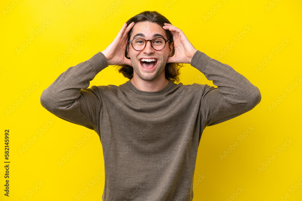 Caucasian handsome man isolated on yellow background with surprise expression Caucasian handsome man isolated on yellow background with surprise expression