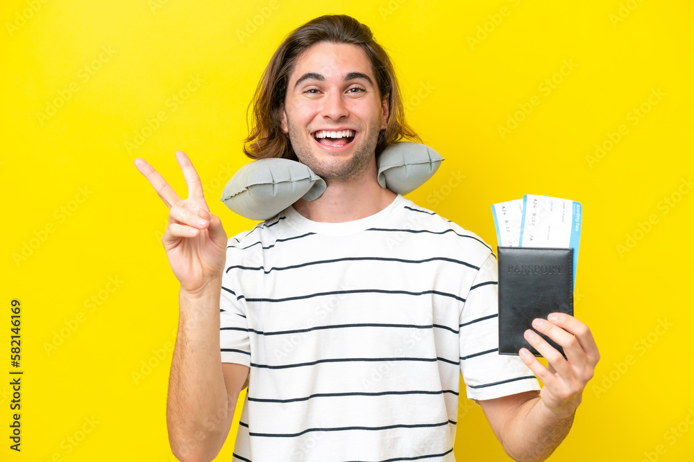handsome Man with Inflatable Travel Pillow smiling and showing victory sign handsome Man with Inflatable Travel Pillow smiling and showing victory sign