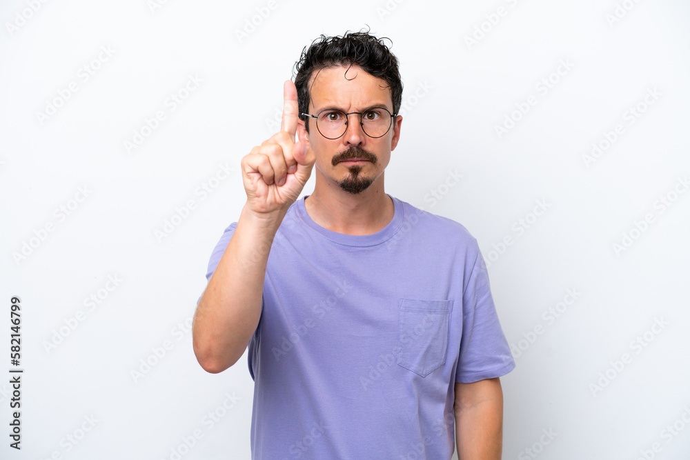 Young man with moustache isolated on white background counting one with serious expression Young man with moustache isolated on white background counting one with serious expression