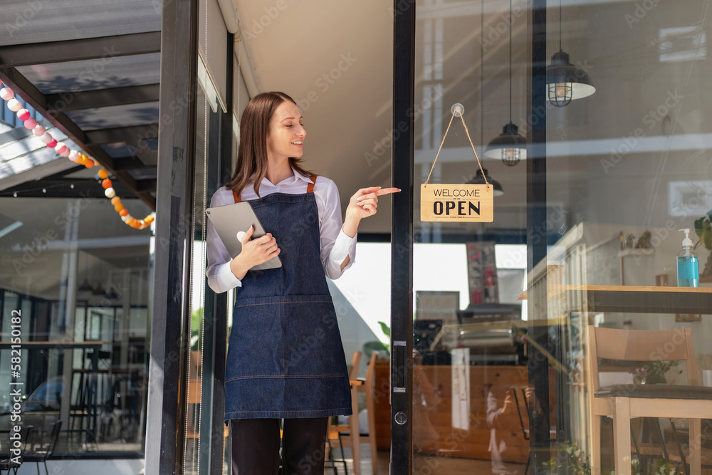 Fototapeta premium Portrait of a woman, a coffee shop business owner smiling beautifully and opening a coffee shop that is her own business, Small business concept..