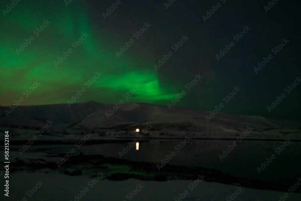 aurora borealis northern lights in karvik town of tromso, norway