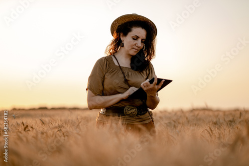 Young woman agronomist checks the quality of grain in the field. Food security in the world. Growing organic crops in Europe.