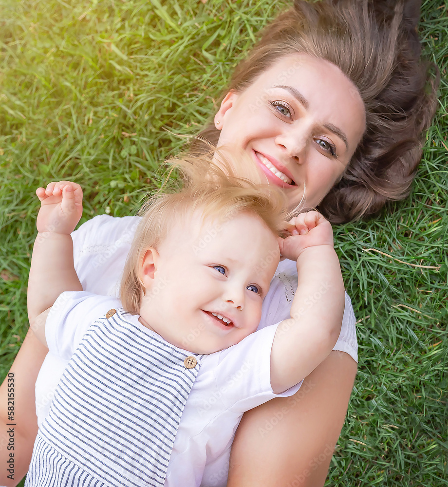 Healthy child (kid) having fun with mother in the sunny summer day.. Caucasians happy baby (boy). Healthy lifestyle, happy childhood, Mother's Day, family concept. Healthy child (kid) having fun with mother in the sunny summer day.. Caucasians happy baby (boy). Healthy lifestyle, happy childhood, Mother's Day, family concept.