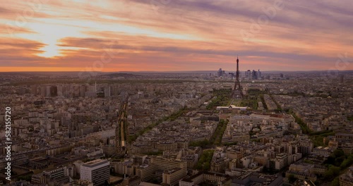 Panoramic aerial view of Paris cityscape with Eiffel Tower and major business district of La Defence in background As the video view of golden sun sets behind the Paris city, lle de France photo