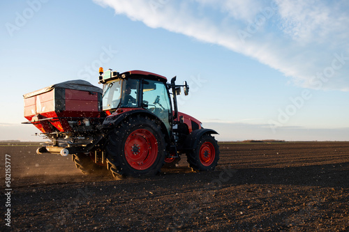 Tractor spreading artificial fertilizers