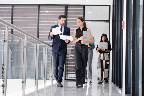 Young businessmen and female employees discussing work details in the office business idea.