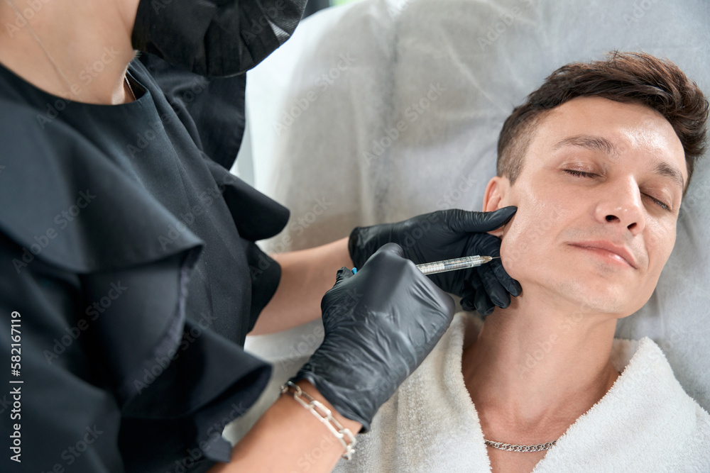 Young male getting face anti age injection