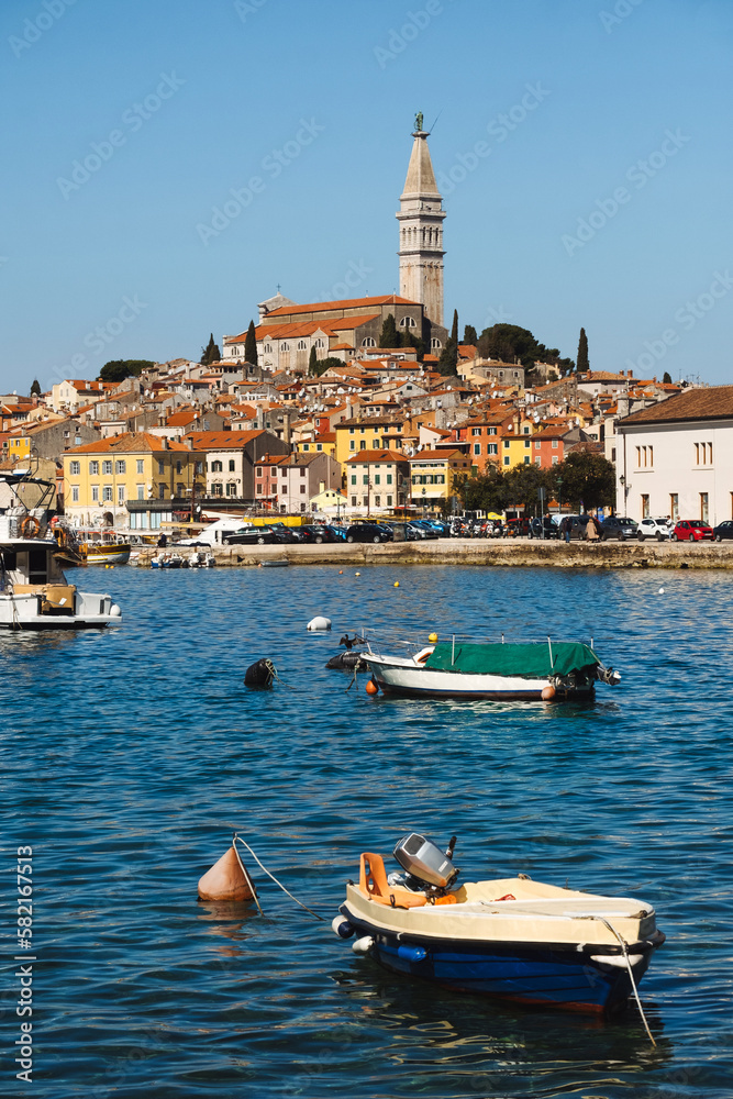 Historic cityscape of Croatian Mediterranean sea coast - old town Rovinj and boats on water of Istria Croatia