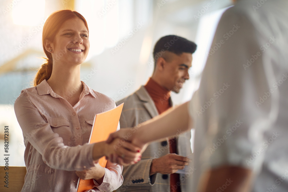 Young employee receiving a congratulations Young employee receiving a congratulations