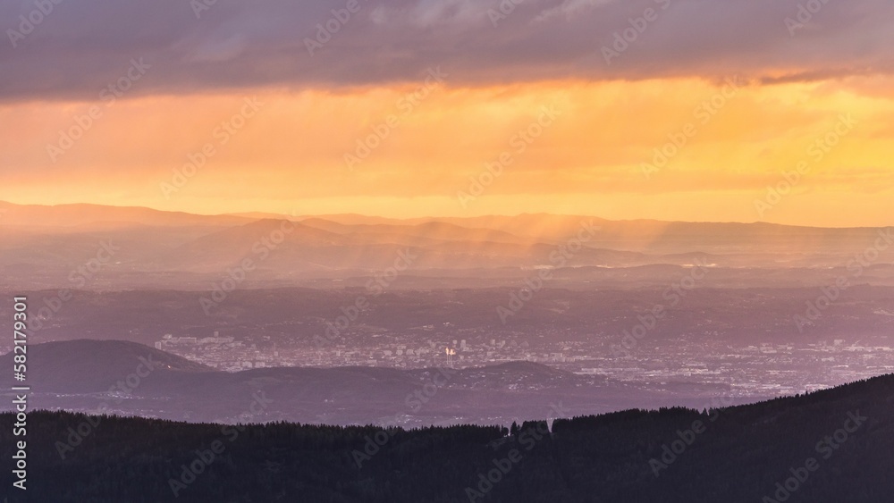 Dramatic Morning view over Graz in Austria during sunrise with some fog and clouds