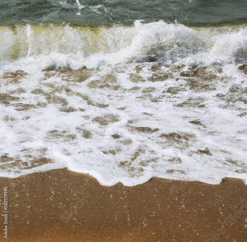 Image of bubbly white waves in the movement on the beach
