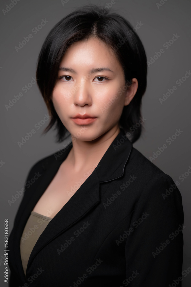 Portrait of an Asian woman wearing a suit. young business woman concept Portrait of an Asian woman wearing a suit. young business woman concept