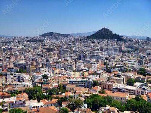Fototapeta Naklejka Na Ścianę i Meble -  Aerial shot of the cityscape of Athens with hundreds of buildings under the blue sky
