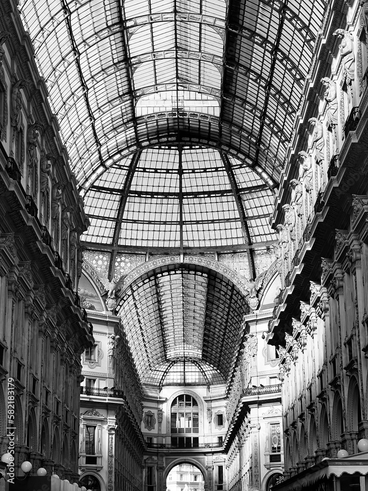 Galleria Vittorio Emanuele II in Milan Italy, perspective photography black and white noir style.