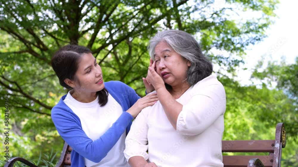 Happy senior mother with gray hair talk and laugh with daughter or caregiver in the park. Concept of happy retirement with care from a caregiver and Savings and senior health insurance, senior care Happy senior mother with gray hair talk and laugh with daughter or caregiver in the park. Concept of happy retirement with care from a caregiver and Savings and senior health insurance, senior care
