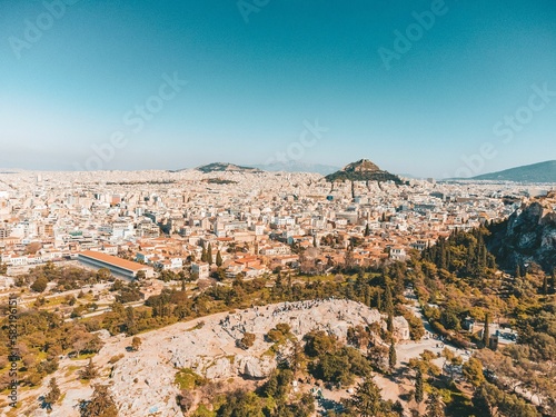 the city of athens from above with hills and trees in the foreground