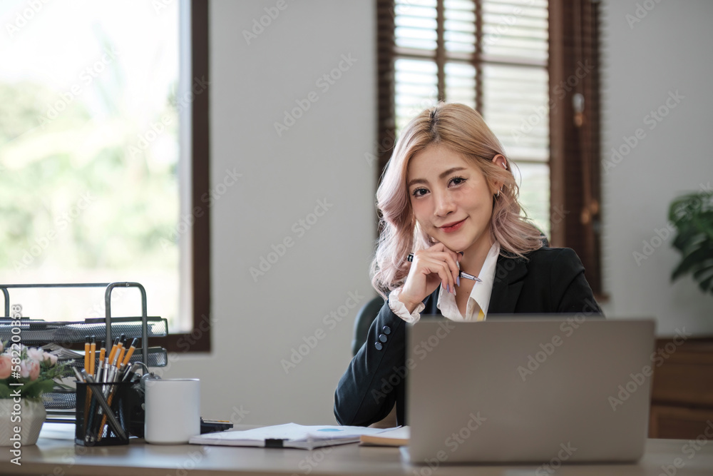 Business woman using calculator for do math finance on wooden desk in office and business working background, tax, accounting, statistics and analytic research concept. Business woman using calculator for do math finance on wooden desk in office and business working background, tax, accounting, statistics and analytic research concept.