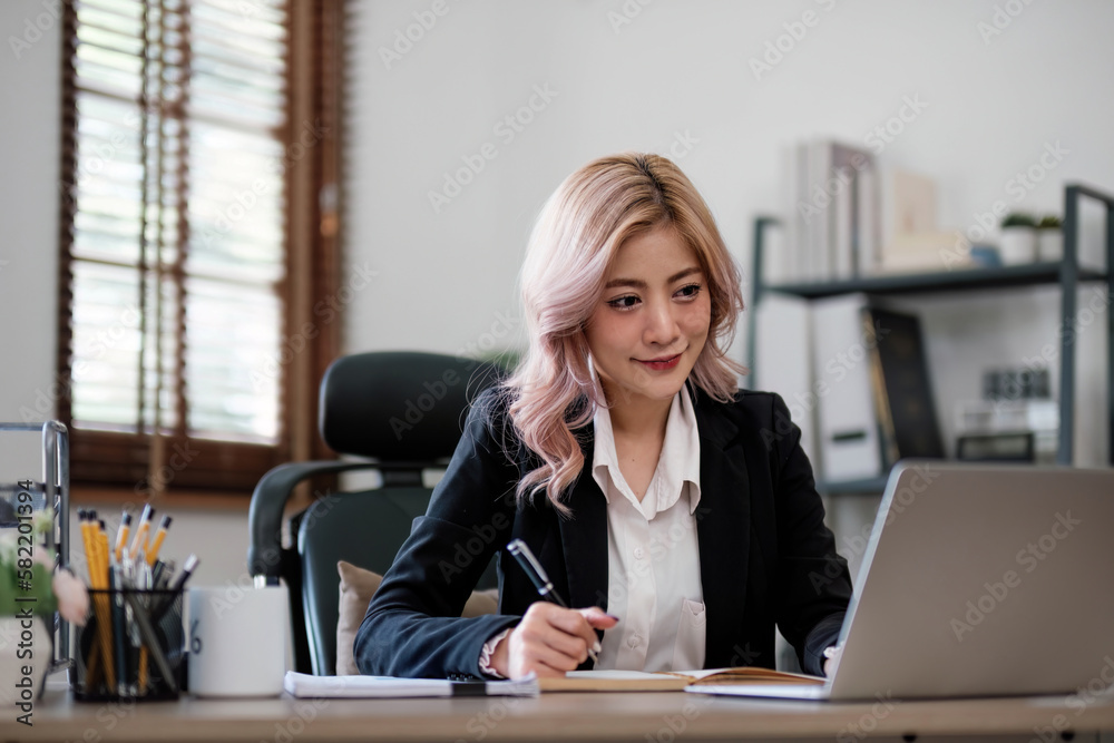 Business woman using calculator for do math finance on wooden desk in office and business working background, tax, accounting, statistics and analytic research concept. Business woman using calculator for do math finance on wooden desk in office and business working background, tax, accounting, statistics and analytic research concept.