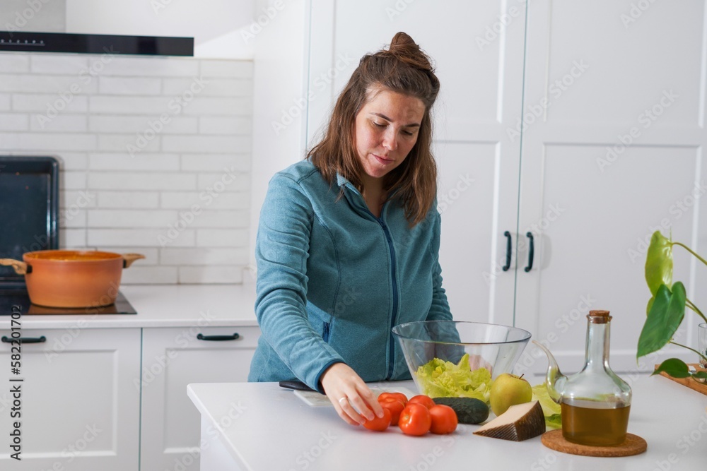 young girl preparing a salad in the kitchen young girl preparing a salad in the kitchen