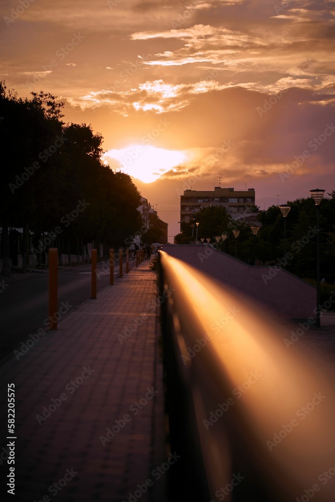 Vertical shot of a cloudy sunset sky over the city