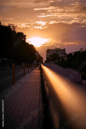 Vertical shot of a cloudy sunset sky over the city © Ruben Toalongo Aguado/Wirestock Creators