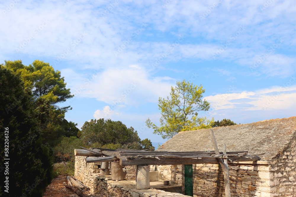 Traditional stone house and wild beach on Proizd, small island near Vela Luka, Croatia.