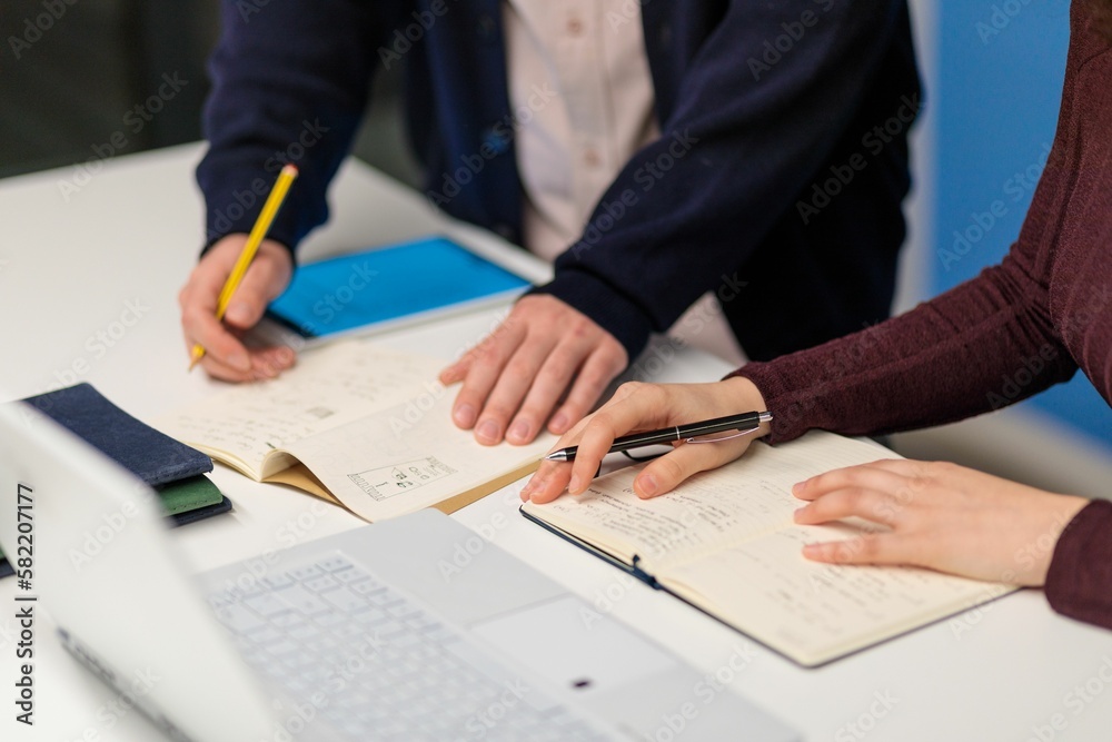 Closeup shot of two office workers signing a document Closeup shot of two office workers signing a document