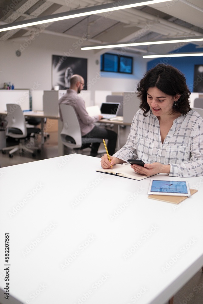 Young employees working and taking notes in the office Young employees working and taking notes in the office