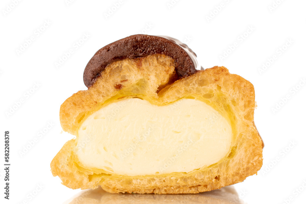 One half of a sweet chocolate eclair, close-up, isolated on a white background. One half of a sweet chocolate eclair, close-up, isolated on a white background.