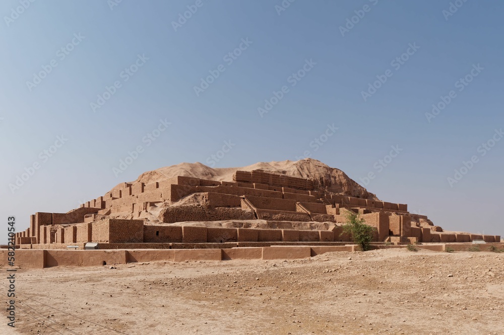 Beautiful shot of the historic Ziggurat of Chogha Zanbil under a blue sky in Khuzestan, Iran