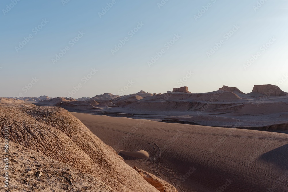An empty desert under a clear blue sky
