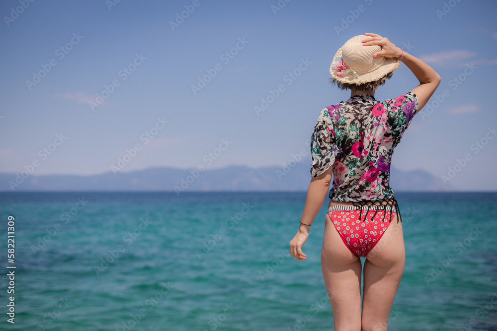 Beach Getaway: Woman in Bikini Enjoying the Sea View