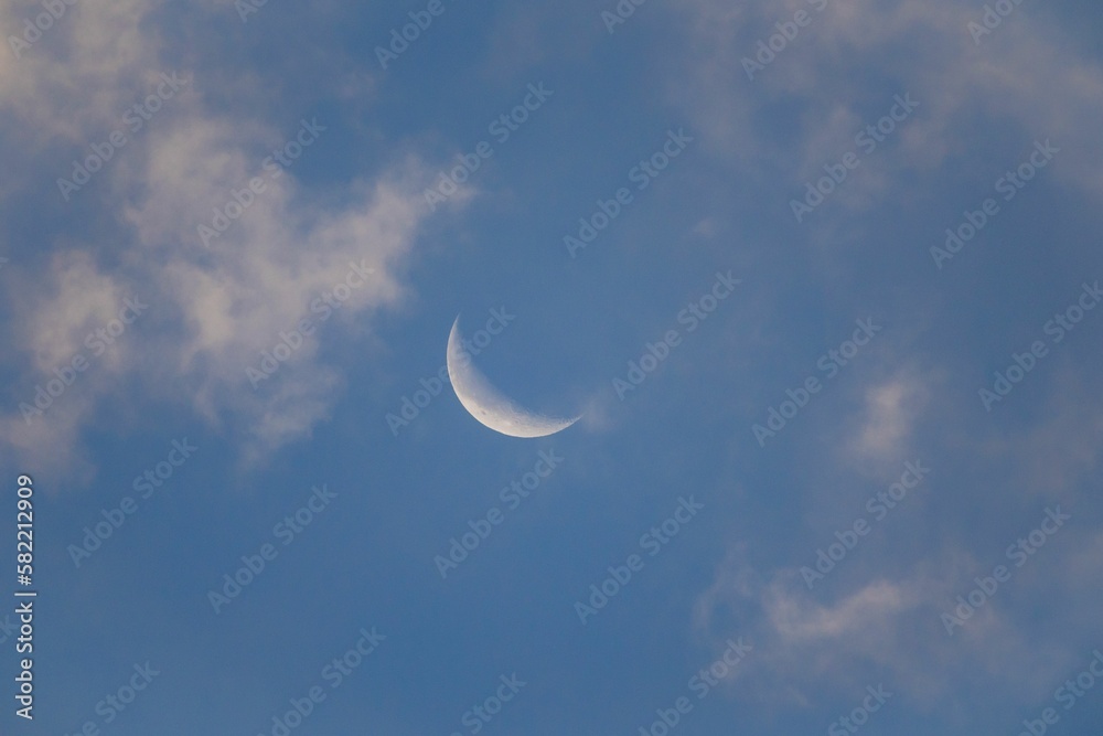 Beautiful view of crescent in cloudy sky Beautiful view of crescent in cloudy sky