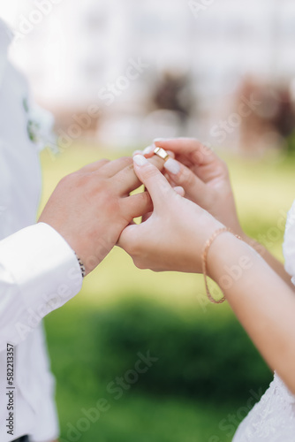 Close up Groom Putting the Wedding Ring on bride © Maksym