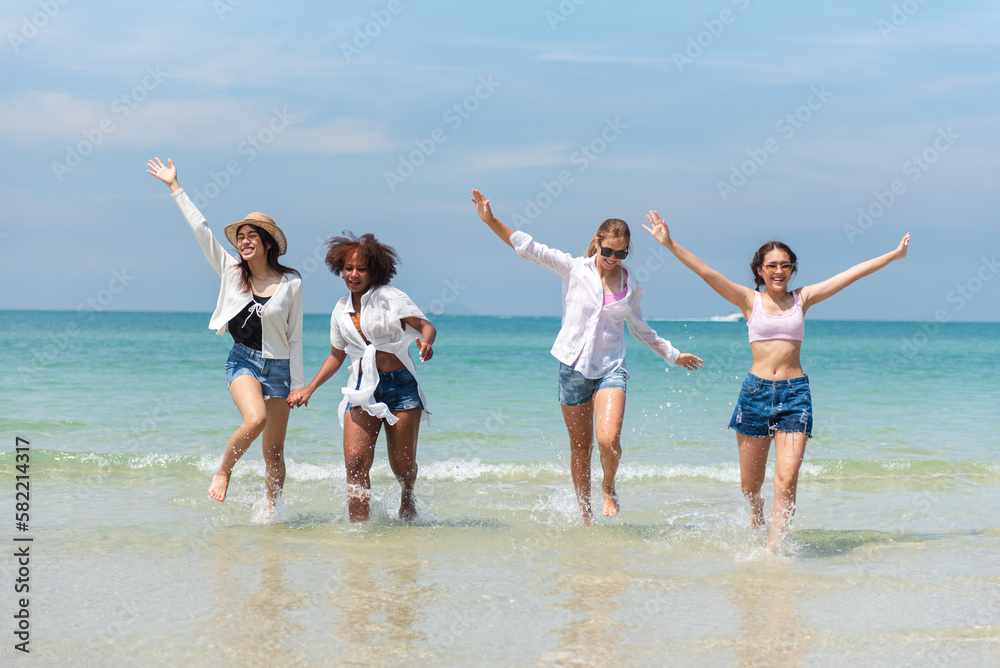Holiday summer diverse teenage friends enjoying on the beach. Group of friends playing in the sea. Lifestyles on vacation and holiday, Travel concept.