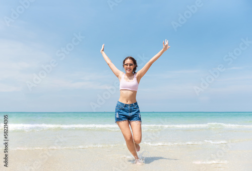 Teenager girl enjoying with beautiful beach, Hipster female running on the beach with happy, Lifestyles on vacation and holiday, Travel concept.